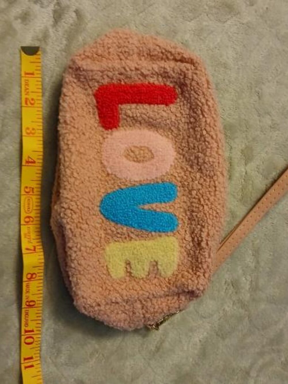 LOVE pink fleece wristlet with zippered closure